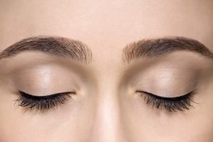Cropped studio shot of beautiful young woman with eyes closed